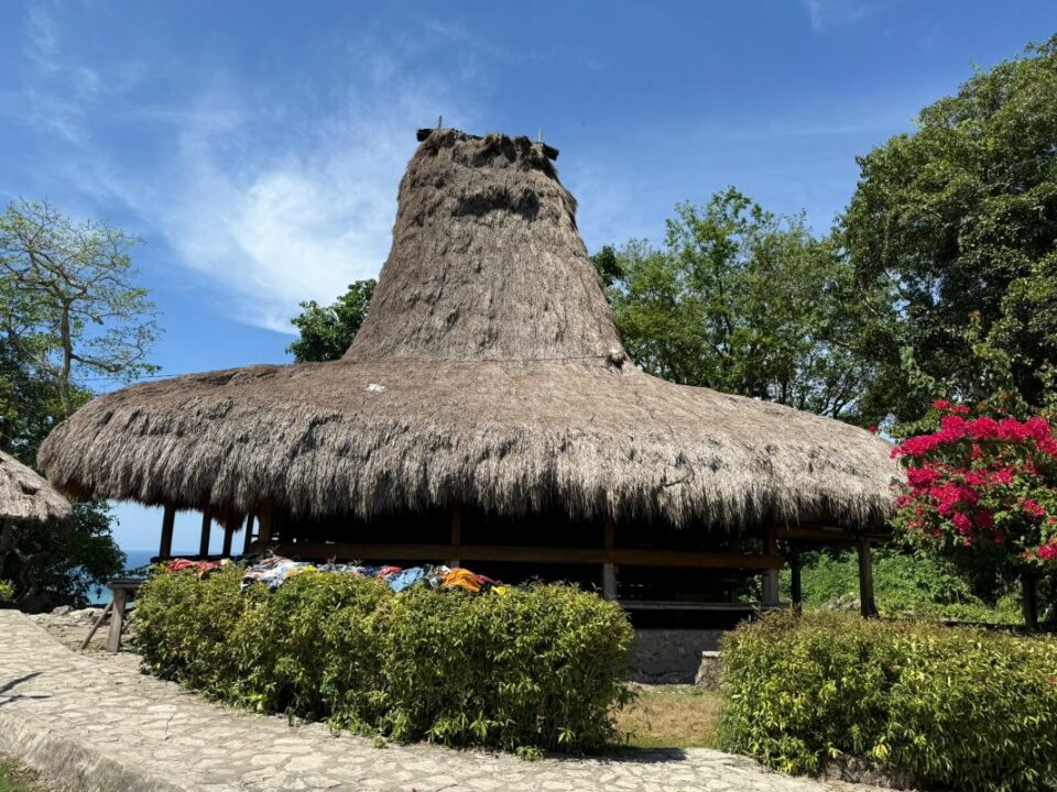 Traditionelles Haus mit hohem Strohdach in einem Dorf auf der indonesischen Insel Sumba.